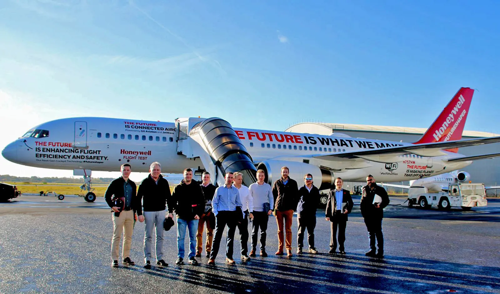 Team standing in front of a Honeywell flight-test aircraft