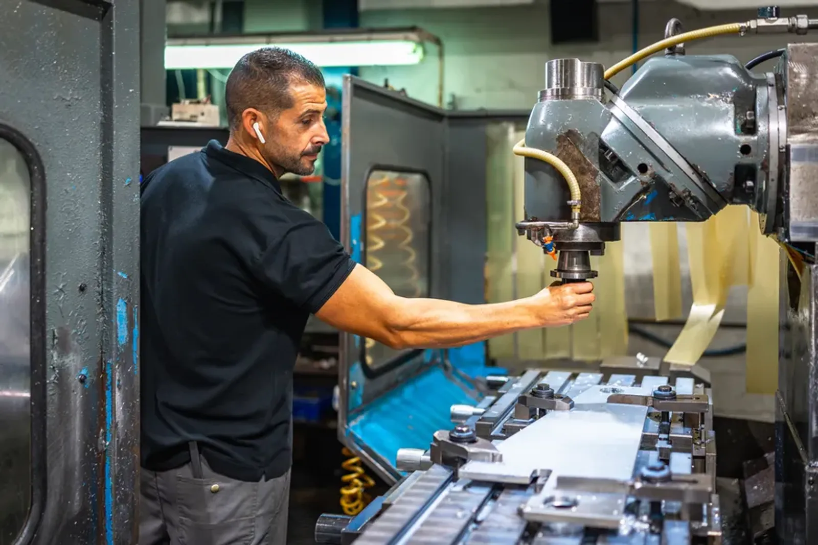Operator working with a milling machine in a factory