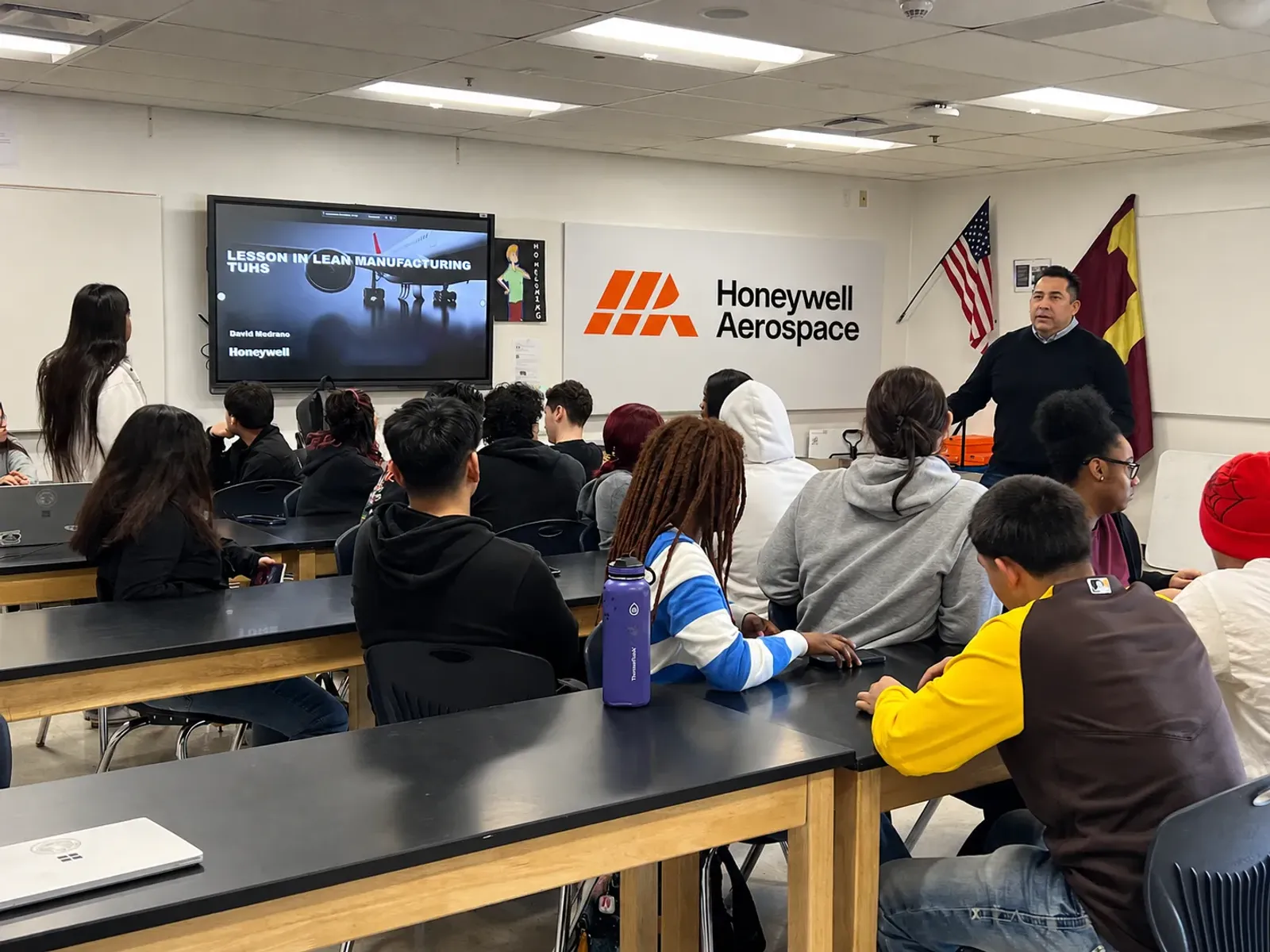 Honeywell Aerospace volunteer teaching a lean manufacturing lesson in a high school classroom