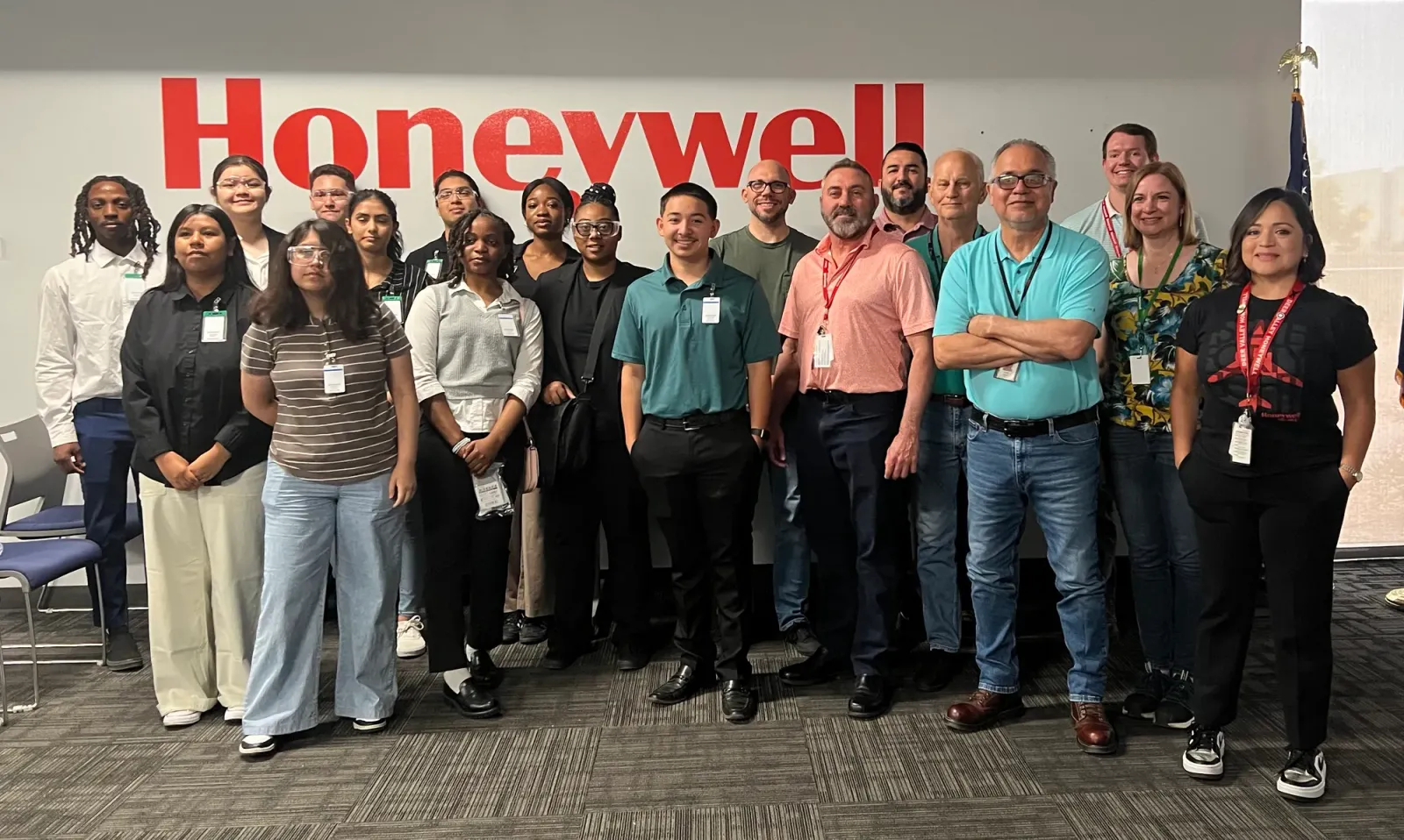 Student cohort and mentors gathered in front of the Honeywell sign