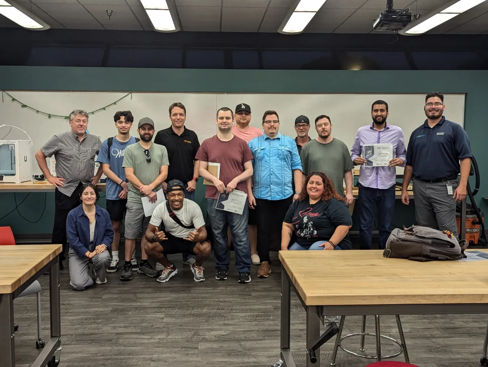 City of Mesa fiber technician cohort holding their certificates in the library maker space