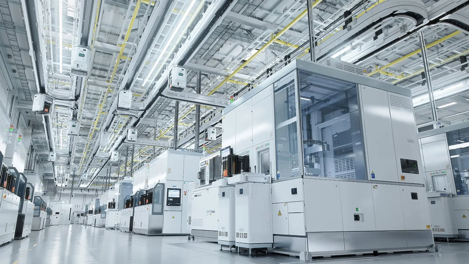 Advanced semiconductor fab equipment lined up in a manufacturing facility